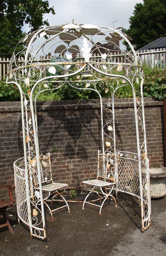White painted iron garden arbour and two chairs
